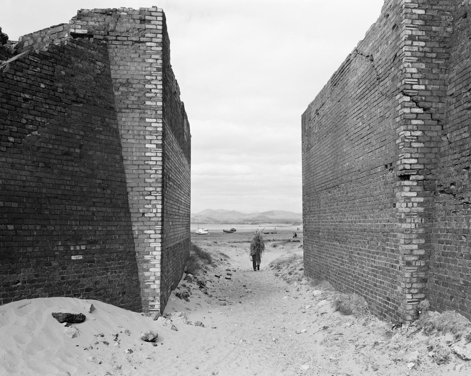 Man carrying sticks, Askam-in-Furness, Cumbria, 1982. © Chris Killip Photography Trust _ Magnum Photos, courtesy of Martin Parr Foundation