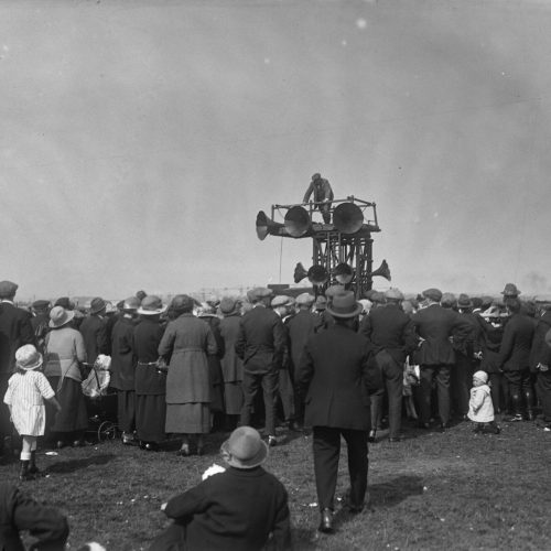 Black and white Sankey image of crowd gathering around speakers
