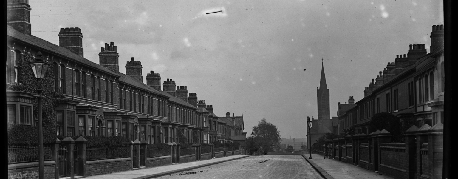 Image number 3648 from the Sankey Photography Archive. The photograph looks South down Brighton Street towards Abbey Road. The street shows terraced housing and a Church spire in the background. © The Sankey Family Photography Collection.